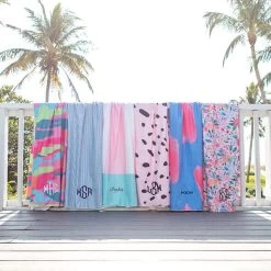 Monogrammed Lightweight Beach Towel -Fashion Clothing Store 2Ee microfiber towels hanging on rail at beach names and monograms