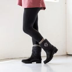 Monogrammed Rain Boots -Fashion Clothing Store 89X black rain boots with leggings standing against white wall