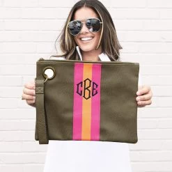 Monogrammed Spencer Wristlet -Fashion Clothing Store Apo close up of girl holding dar olive wristlet