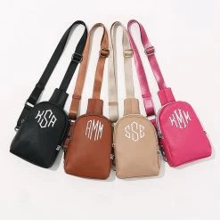 Monogrammed Sling Bag -Fashion Clothing Store Cyy studio shot of black brown tan and pink sling bags