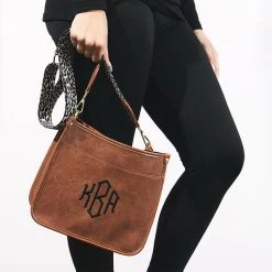 Monogrammed Saddlebag -Fashion Clothing Store DkA close up of girl holding new ivory leopard saddlebag