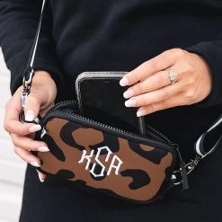 Monogrammed Neoprene Phone Crossbody -Fashion Clothing Store Gh0 phone in pocket of monogrammed neoprene crossbody in leopard