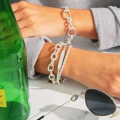 Personalized Bracelet -Fashion Clothing Store J4s silver personalized bracelet paried with silver bracelets on cafe table