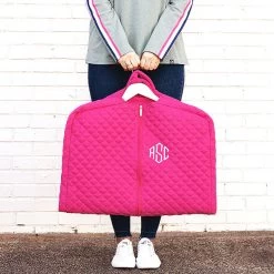 Monogrammed Diamond Quilted Garment Bag -Fashion Clothing Store JEO girl holding hot pink diamond quilted garment bag