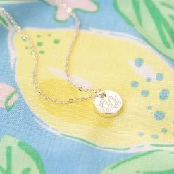 Monogrammed Tiny Disc Necklace -Fashion Clothing Store OsI silver monogrammed disc necklace on lemonade pattern