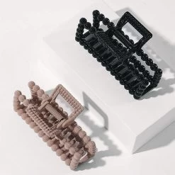 Hair Clip Set -Fashion Clothing Store Phb studio shot of mauve and black hair clip set