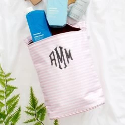 Monogrammed Ditty Bag 11 Monogrammed Ditty Bag -Fashion Clothing Store RuV pink and white strip ditty bag on sheet with contents spilling out close
