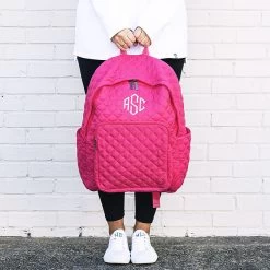 Monogrammed Quilted Laptop Backpack -Fashion Clothing Store SRe hot pink quilted laptop backpack in hands