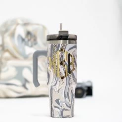 Monogrammed Travel Tumbler 18 Monogrammed Travel Tumbler -Fashion Clothing Store UAf nuetral marble in studio with canmera and backpack