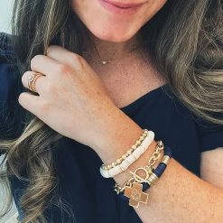Monogrammed Cross Pendant Bracelet -Fashion Clothing Store Wh7 monogrammed gold bracelet with cross pendant on wrist
