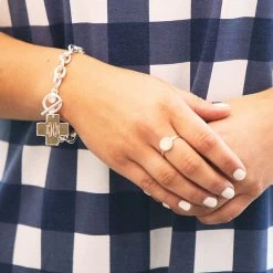 Monogrammed Cross Pendant Bracelet -Fashion Clothing Store Wh7 silver chain bracelet with monogrammed cross pendant on wrist