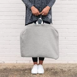 Monogrammed Quilted Garment Bag -Fashion Clothing Store bgi updated monogram placement girl holding quilted garment bag in gray