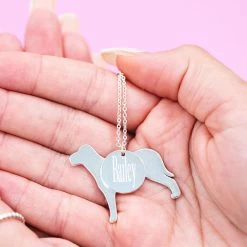 Monogrammed Dog Necklace -Fashion Clothing Store jnH silver dog charm necklace in hands