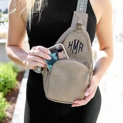 Monogrammed Sling Purse -Fashion Clothing Store qft close up of girl wearing taupe sling purse