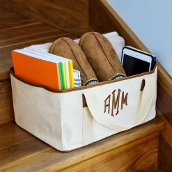 Monogrammed Stair Basket -Fashion Clothing Store sjU stari basket on stairs filled with slippers books ipad