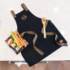 Monogrammed Apron -Fashion Clothing Store t0U black apron flatlay