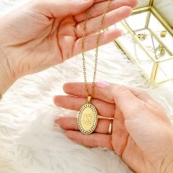 Monogrammed Pave Necklace -Fashion Clothing Store uQU pave gold necklace in hands with fur