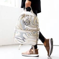 Monogrammed Neoprene Backpack -Fashion Clothing Store y9H neutral marble in hand of girl walking in studio